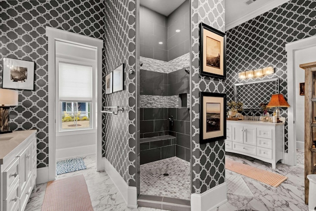 bathroom featuring vanity, ornamental molding, and a tile shower