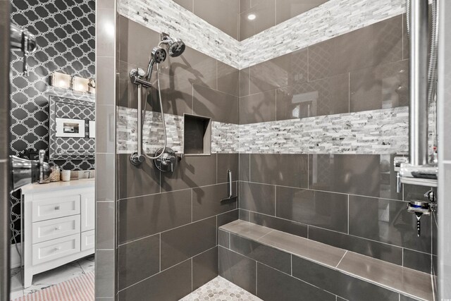 bathroom with a tile shower