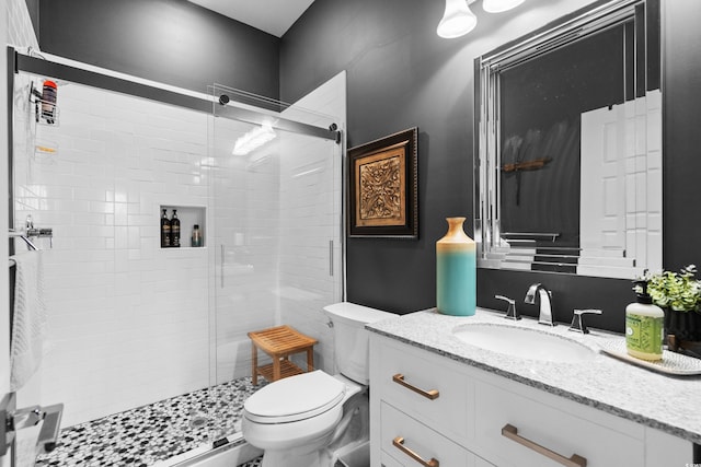 bathroom with vanity, toilet, and an enclosed shower