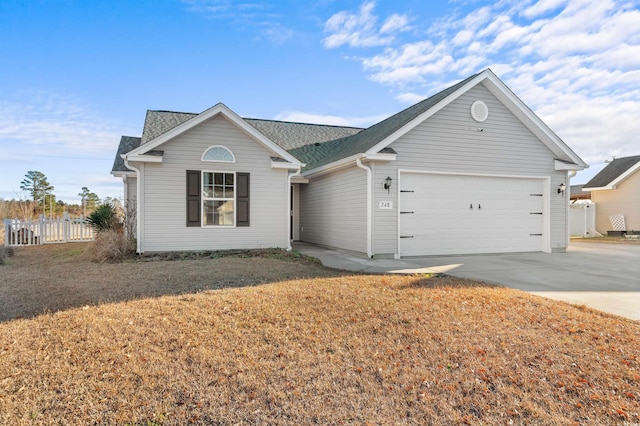 single story home featuring a garage and a front lawn