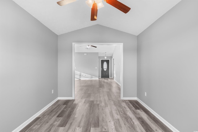 hall with vaulted ceiling and hardwood / wood-style flooring