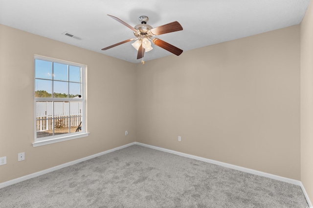 carpeted empty room featuring ceiling fan