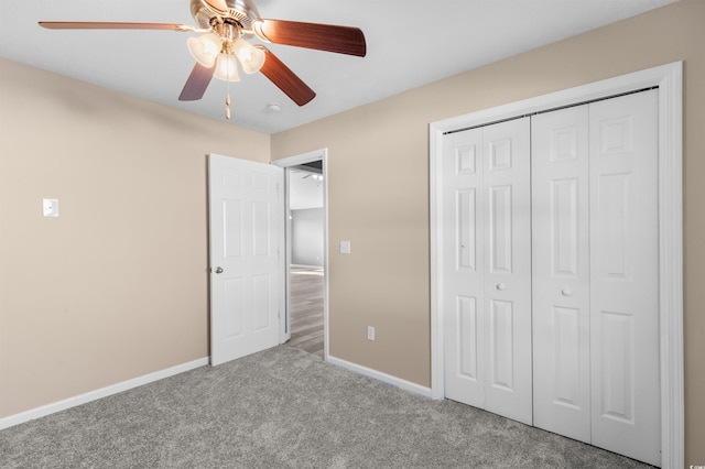 unfurnished bedroom featuring carpet, ceiling fan, and a closet