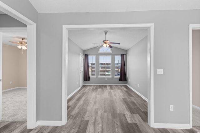 interior space featuring hardwood / wood-style floors, ceiling fan, and vaulted ceiling