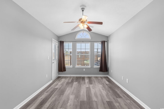 unfurnished room featuring wood-type flooring, ceiling fan, and lofted ceiling