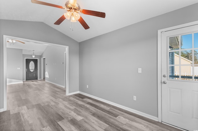 foyer entrance with light wood-type flooring, ceiling fan, and lofted ceiling