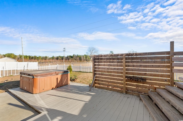 wooden deck featuring a hot tub