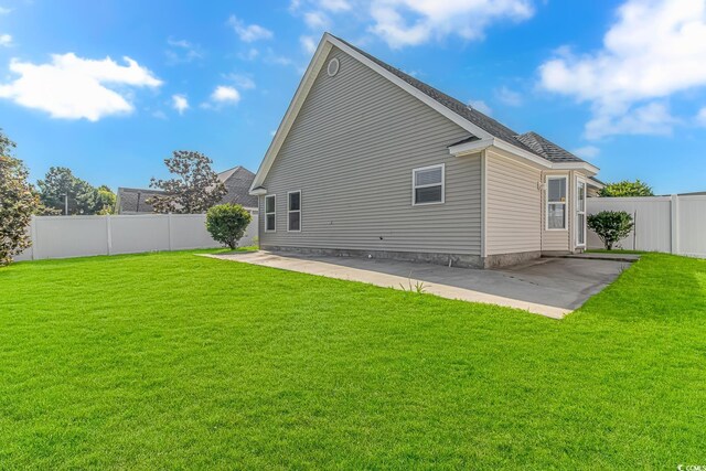 back of house with a patio, a yard, and a fenced backyard