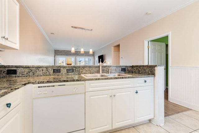 kitchen featuring white cabinets, white dishwasher, dark stone counters, and sink