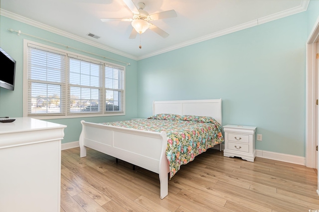 bedroom featuring light wood-type flooring, ceiling fan, and crown molding