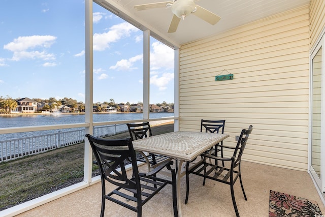 sunroom with a water view, plenty of natural light, and ceiling fan