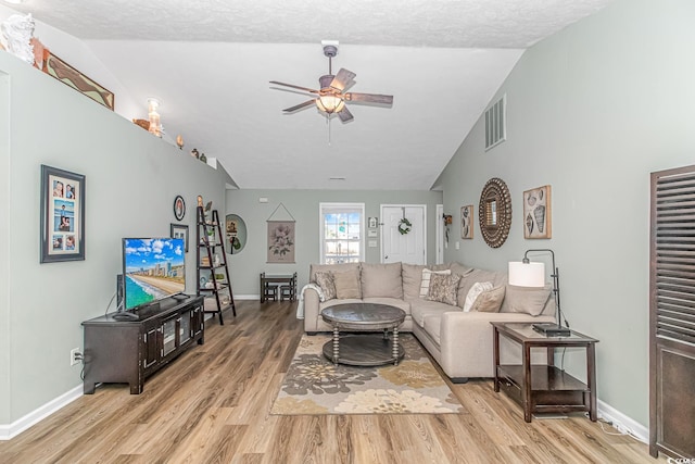 living room with lofted ceiling, baseboards, light wood-style flooring, and a ceiling fan