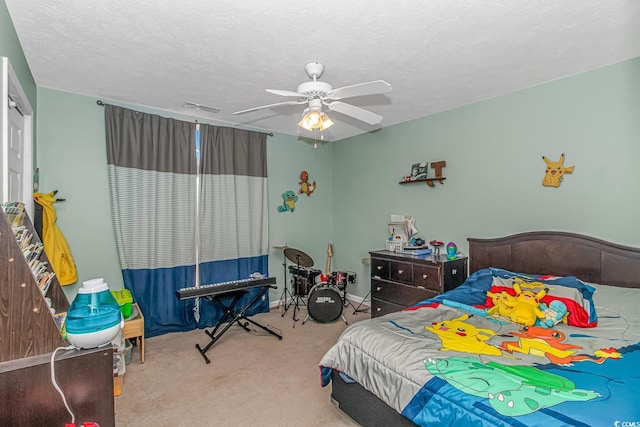 bedroom with carpet floors, visible vents, a textured ceiling, and a ceiling fan