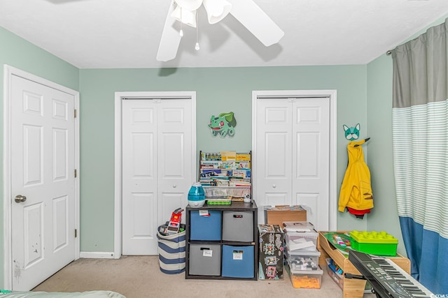 recreation room with carpet floors, baseboards, and a ceiling fan