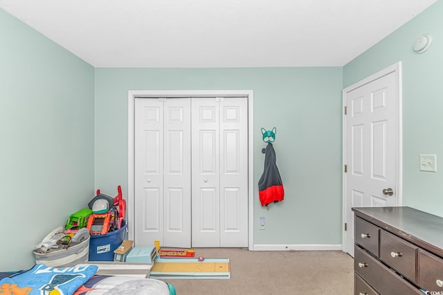 rec room with baseboards and light colored carpet