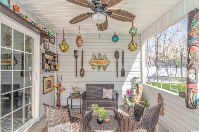 sunroom with a ceiling fan