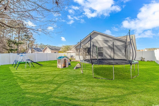 view of yard featuring a fenced backyard and a trampoline