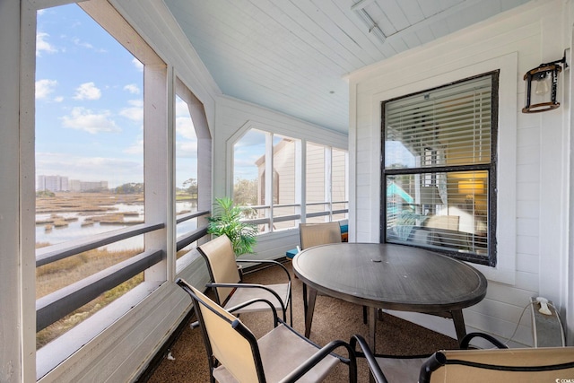 sunroom / solarium with a water view