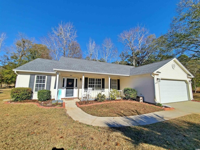 ranch-style home featuring covered porch, a garage, and a front yard