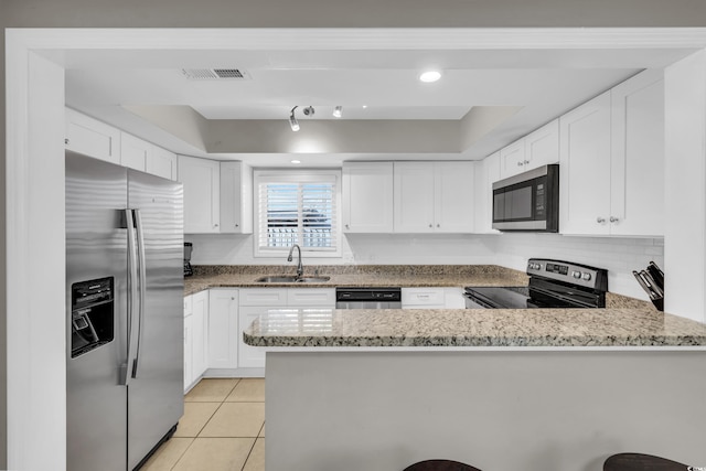 kitchen featuring kitchen peninsula, sink, white cabinets, and appliances with stainless steel finishes