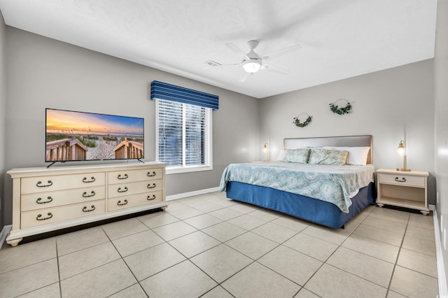 tiled bedroom featuring ceiling fan