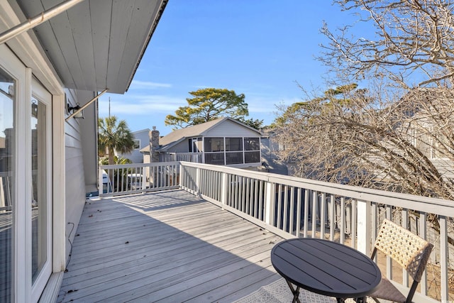 wooden deck featuring a sunroom