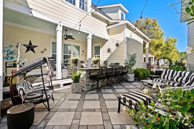 view of patio / terrace featuring exterior bar and ceiling fan