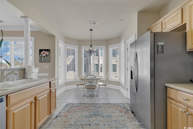 kitchen with stainless steel fridge with ice dispenser, sink, a healthy amount of sunlight, and light tile patterned flooring