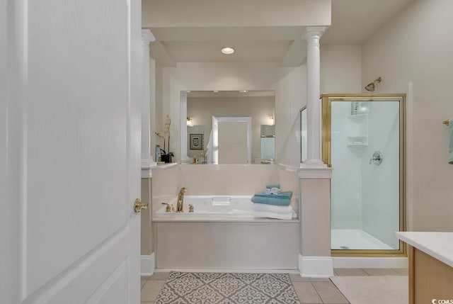 bathroom featuring vanity, tile patterned floors, plus walk in shower, and ornate columns