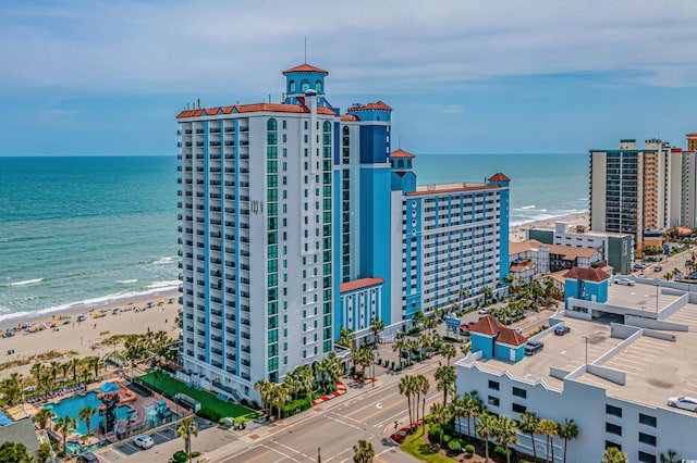 birds eye view of property with a water view and a view of the beach