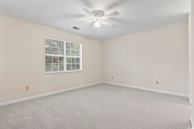 carpeted empty room featuring ceiling fan