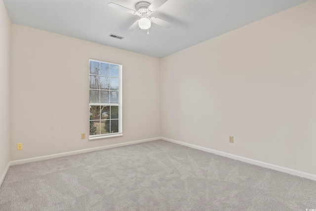 unfurnished room featuring ceiling fan and light colored carpet