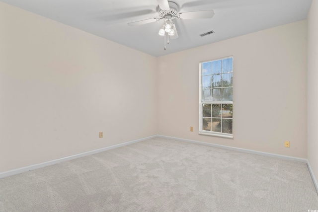 carpeted spare room featuring ceiling fan