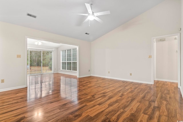 spare room featuring dark hardwood / wood-style flooring, vaulted ceiling, and ceiling fan