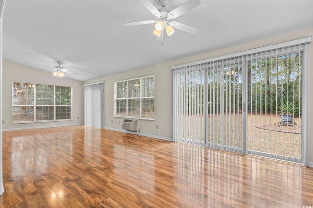 unfurnished living room with hardwood / wood-style flooring, ceiling fan, lofted ceiling, and plenty of natural light