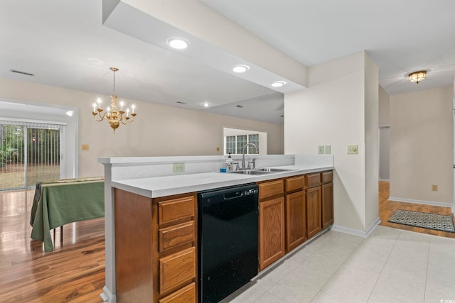 kitchen with sink, a chandelier, hanging light fixtures, kitchen peninsula, and dishwasher