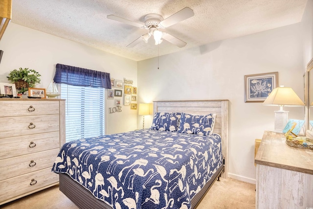 carpeted bedroom featuring a textured ceiling and ceiling fan