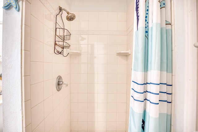 full bath featuring a tile shower