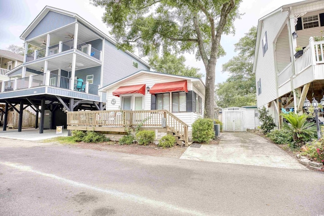 view of front of house featuring a balcony, cooling unit, and a carport