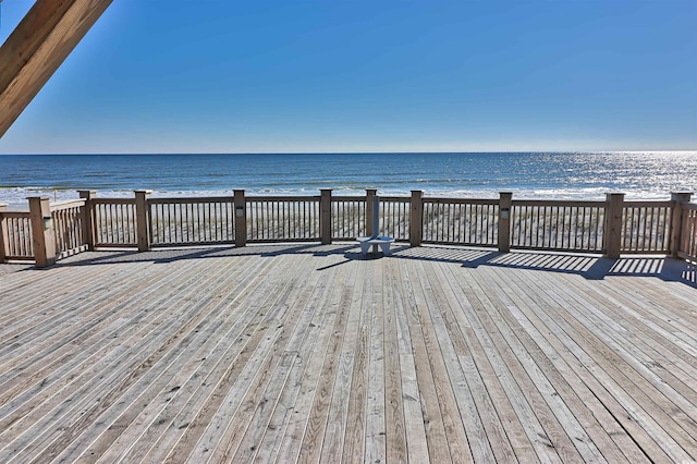 wooden terrace with a water view and a beach view