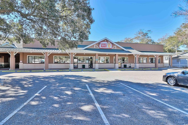 view of building exterior with uncovered parking