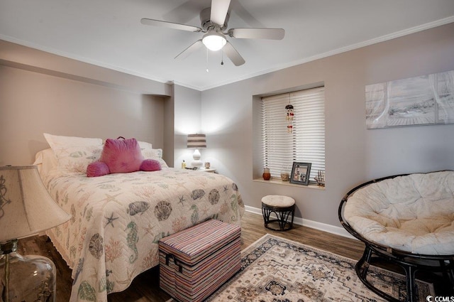 bedroom with a ceiling fan, baseboards, crown molding, and wood finished floors