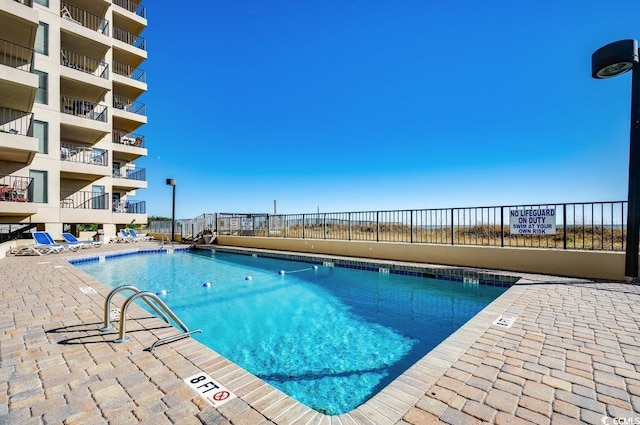 view of swimming pool with fence