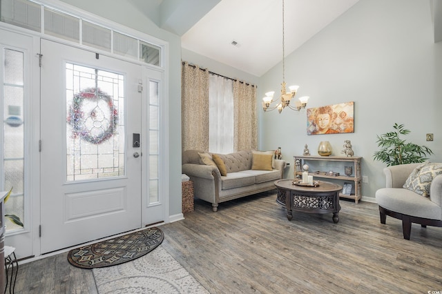 entryway featuring a chandelier, hardwood / wood-style flooring, and high vaulted ceiling