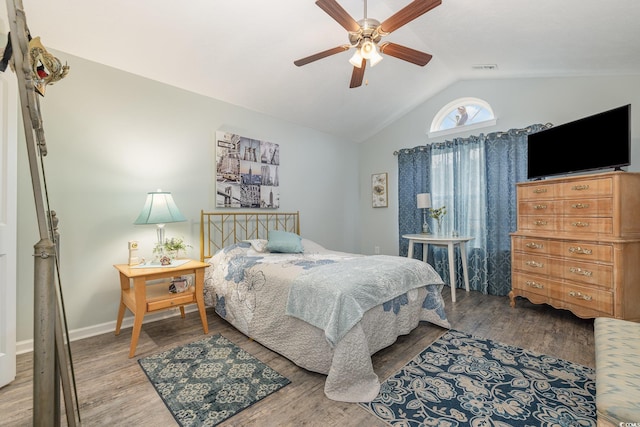 bedroom with ceiling fan, wood-type flooring, and vaulted ceiling