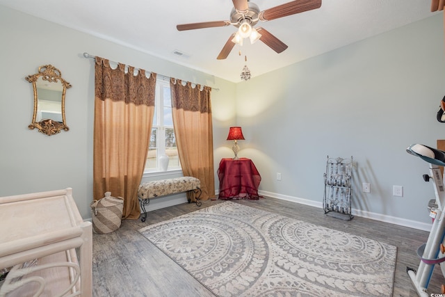 living area with ceiling fan and hardwood / wood-style floors