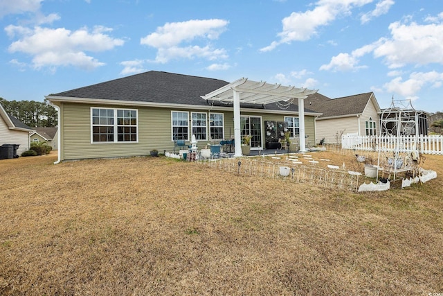 back of property with a pergola, a lawn, and a patio