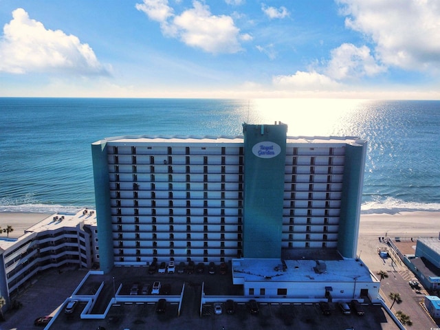 drone / aerial view featuring a water view and a beach view