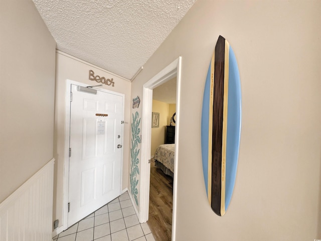 entrance foyer featuring light tile patterned flooring and a textured ceiling