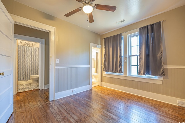 unfurnished room with ceiling fan and wood-type flooring